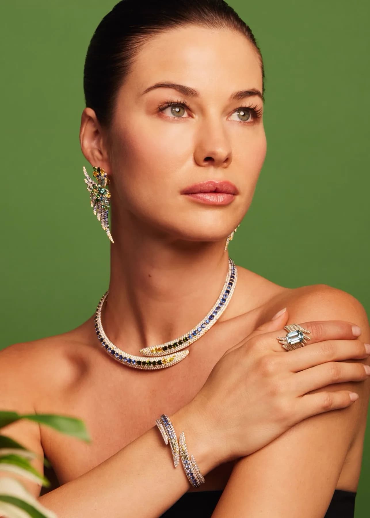 A model wearing a full 7MARK gemstone suite — earrings, necklace, ring, and bangle